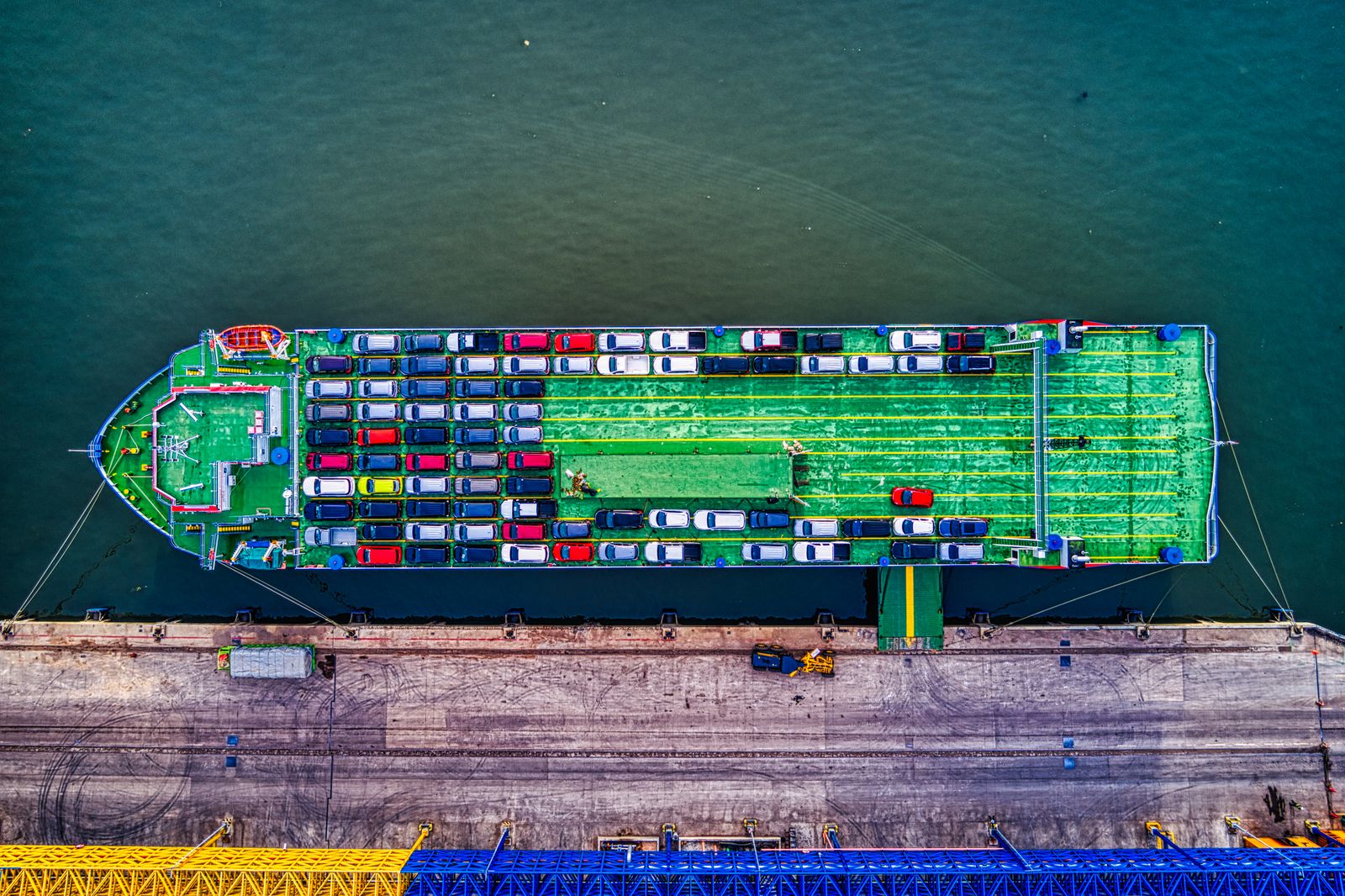 Aerial view of a vehicle export yard beside a quay