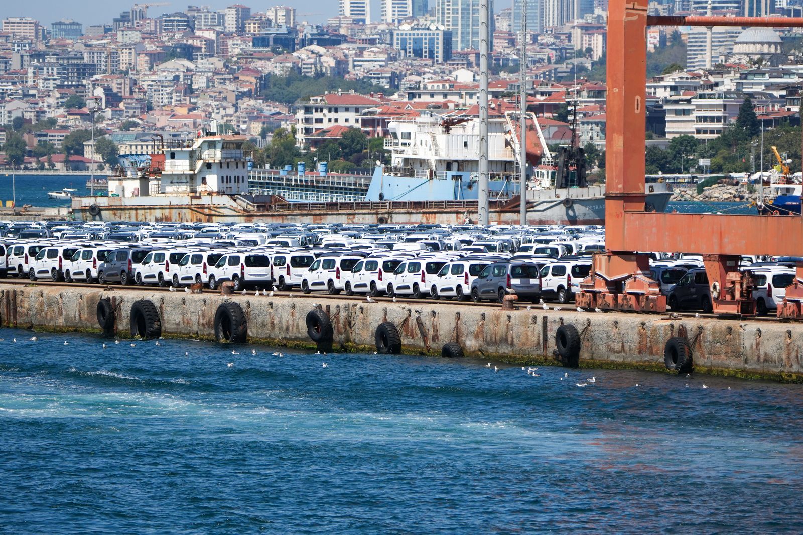 Aerial view of a vehicle export yard beside a quay