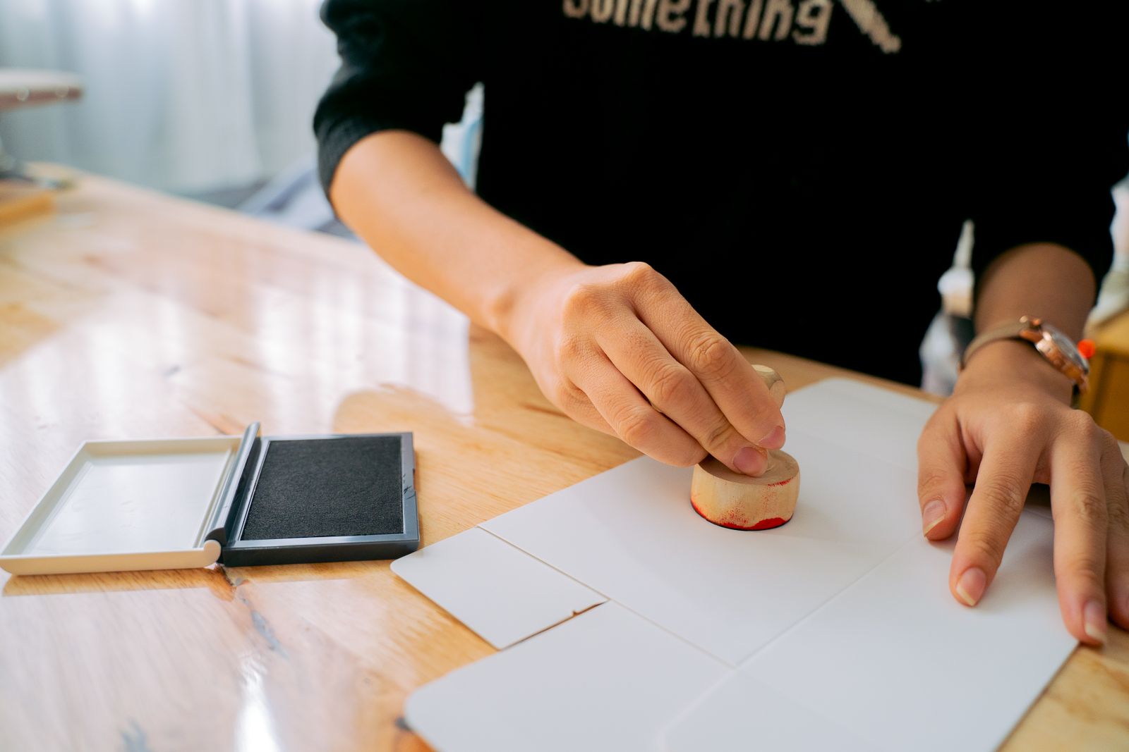 A hand stamping a vehicle ownership document